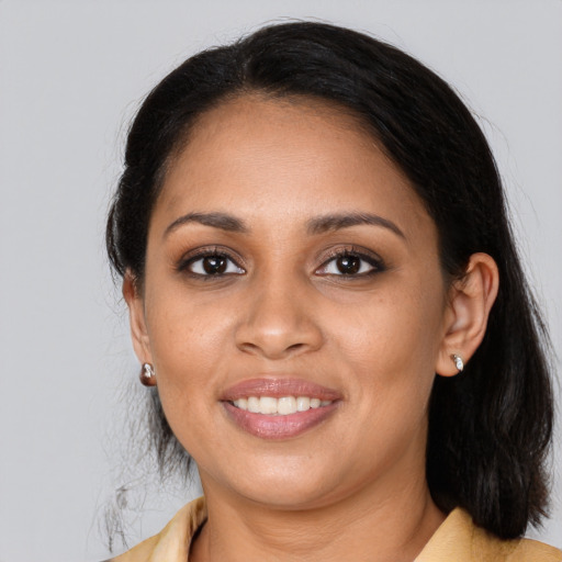 Joyful latino young-adult female with medium  brown hair and brown eyes