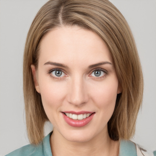 Joyful white young-adult female with medium  brown hair and grey eyes