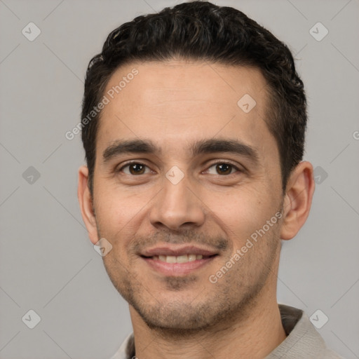 Joyful white young-adult male with short  black hair and brown eyes