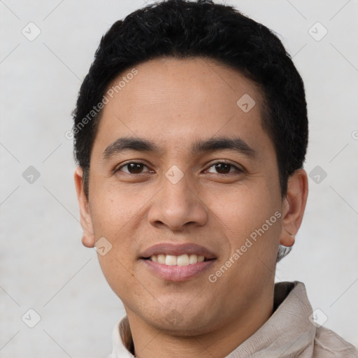 Joyful latino young-adult male with short  black hair and brown eyes