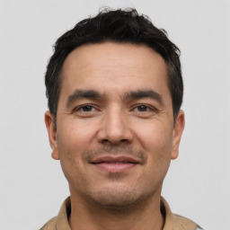 Joyful white young-adult male with short  black hair and brown eyes