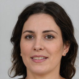 Joyful white adult female with medium  brown hair and brown eyes