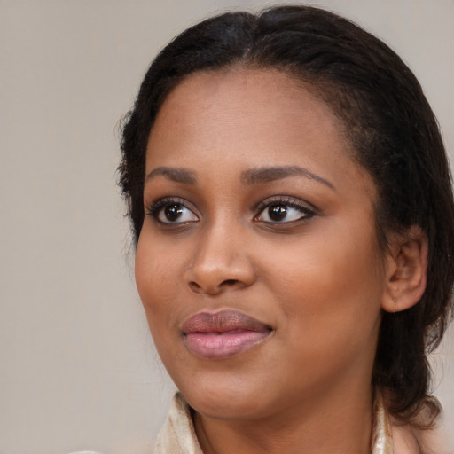 Joyful black young-adult female with medium  brown hair and brown eyes