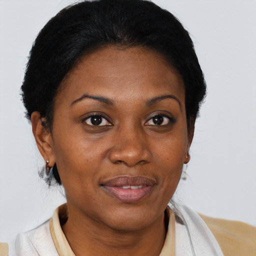 Joyful black adult female with short  brown hair and brown eyes
