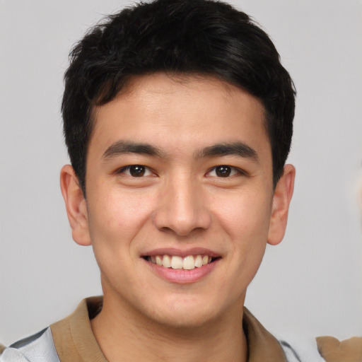 Joyful asian young-adult male with short  brown hair and brown eyes