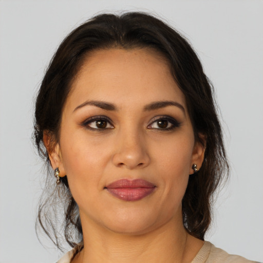 Joyful latino young-adult female with medium  brown hair and brown eyes