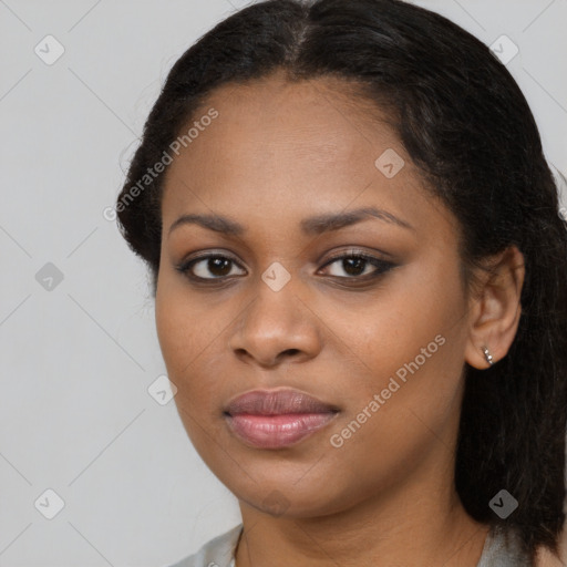 Joyful black young-adult female with long  brown hair and brown eyes