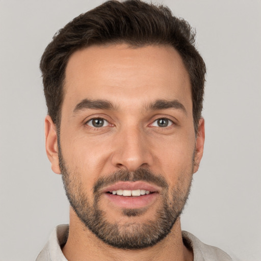 Joyful white young-adult male with short  brown hair and brown eyes