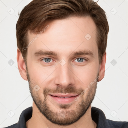 Joyful white young-adult male with short  brown hair and grey eyes