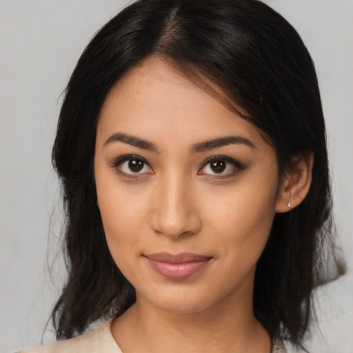 Joyful latino young-adult female with medium  brown hair and brown eyes