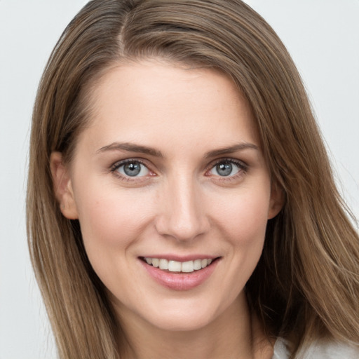 Joyful white young-adult female with long  brown hair and grey eyes