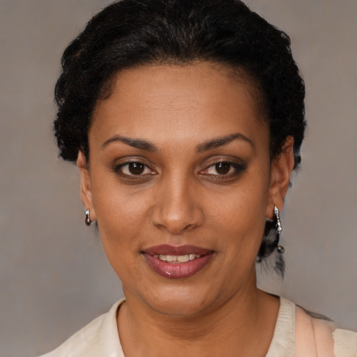Joyful black young-adult female with short  brown hair and brown eyes