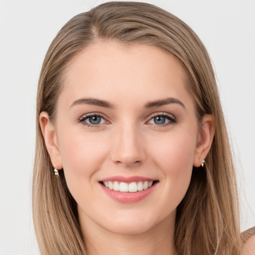 Joyful white young-adult female with long  brown hair and grey eyes