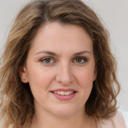 Joyful white young-adult female with long  brown hair and green eyes