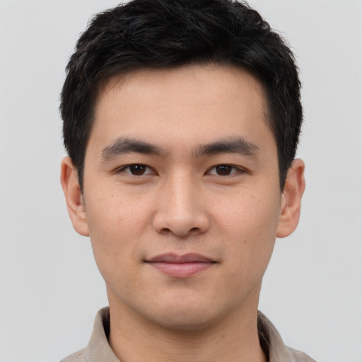 Joyful white young-adult male with short  black hair and brown eyes