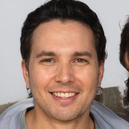 Joyful white adult male with short  brown hair and brown eyes