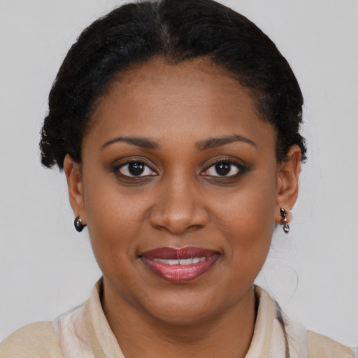 Joyful black young-adult female with medium  brown hair and brown eyes