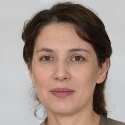 Joyful white adult female with medium  brown hair and grey eyes