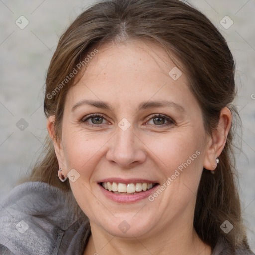 Joyful white adult female with medium  brown hair and grey eyes