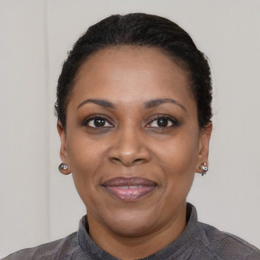 Joyful black adult female with short  black hair and brown eyes