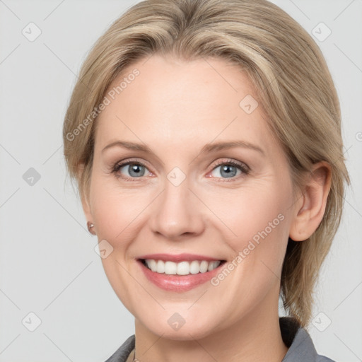 Joyful white young-adult female with medium  brown hair and blue eyes