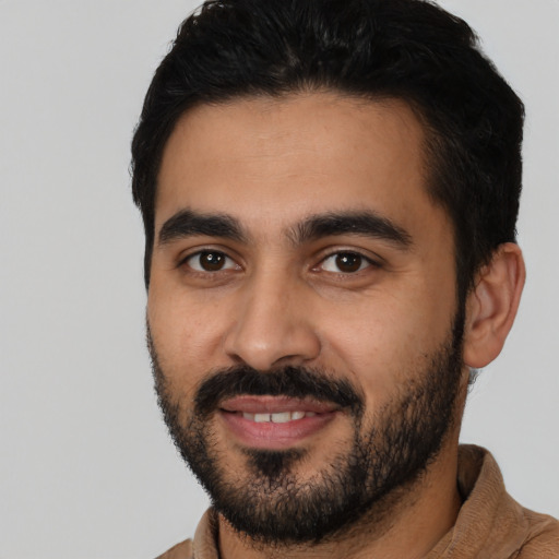 Joyful latino young-adult male with short  black hair and brown eyes
