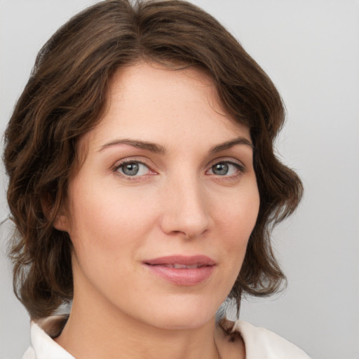 Joyful white young-adult female with medium  brown hair and green eyes