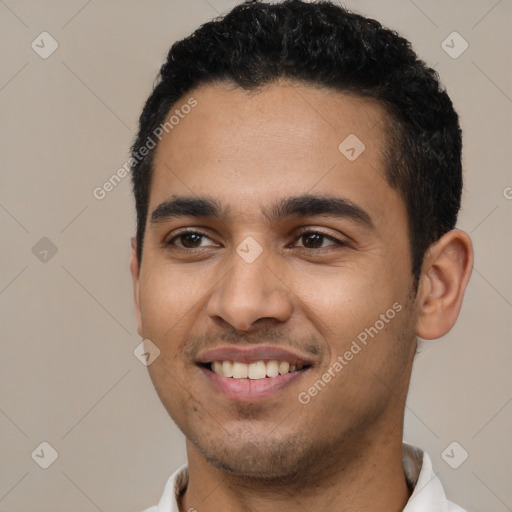 Joyful latino young-adult male with short  black hair and brown eyes