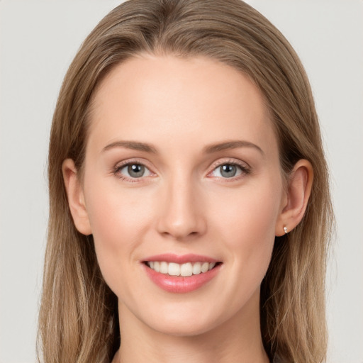 Joyful white young-adult female with long  brown hair and blue eyes