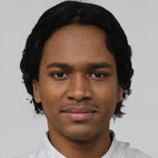 Joyful black young-adult male with short  black hair and brown eyes