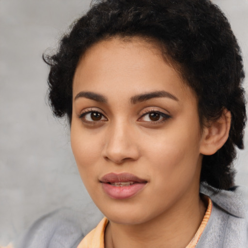 Joyful latino young-adult female with short  black hair and brown eyes