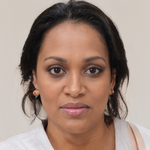 Joyful black adult female with medium  brown hair and brown eyes