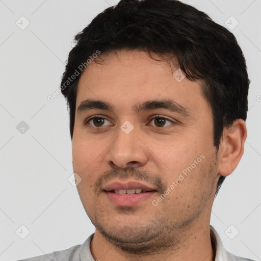 Joyful white young-adult male with short  black hair and brown eyes