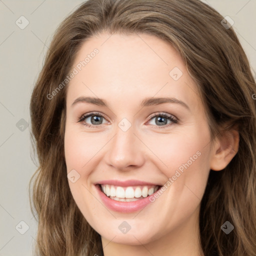 Joyful white young-adult female with long  brown hair and green eyes