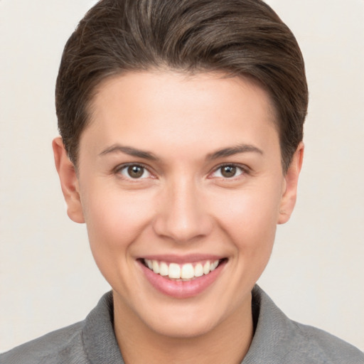 Joyful white young-adult female with short  brown hair and brown eyes