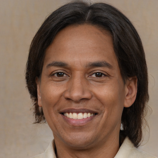 Joyful latino adult male with medium  brown hair and brown eyes