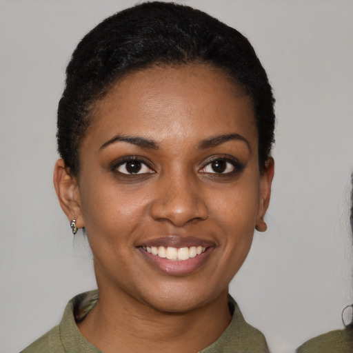 Joyful black young-adult female with short  black hair and brown eyes