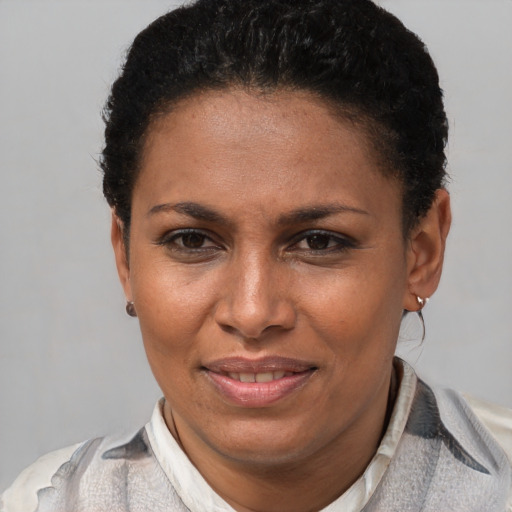 Joyful latino young-adult female with short  brown hair and brown eyes