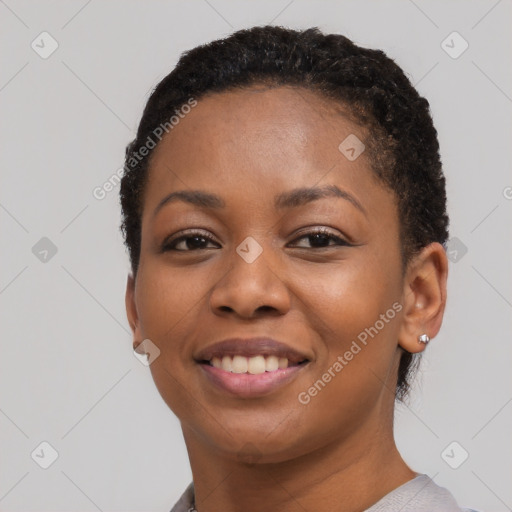 Joyful black young-adult female with short  brown hair and brown eyes