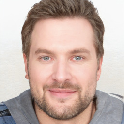 Joyful white young-adult male with short  brown hair and grey eyes