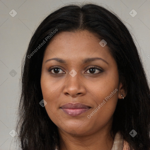 Joyful black young-adult female with long  brown hair and brown eyes