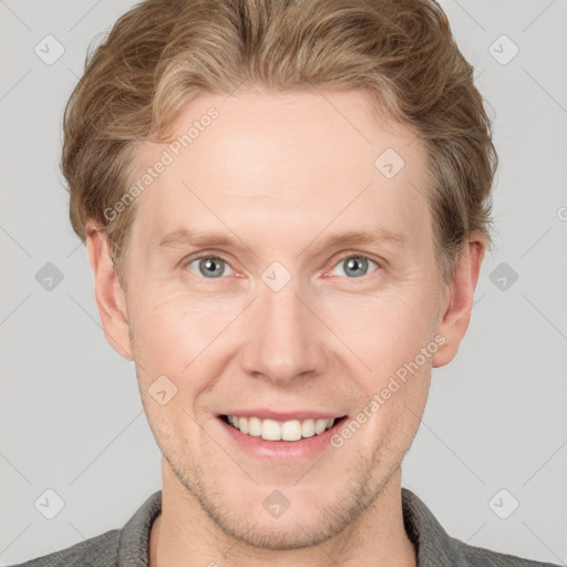 Joyful white adult male with short  brown hair and grey eyes