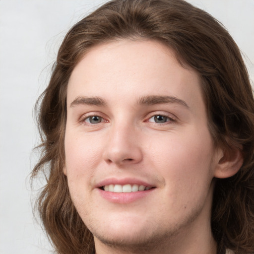 Joyful white young-adult female with long  brown hair and grey eyes