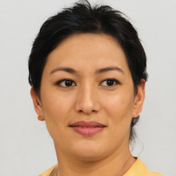 Joyful asian young-adult female with short  brown hair and brown eyes