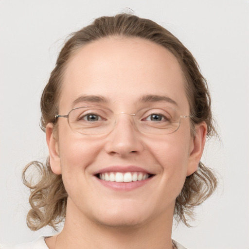 Joyful white young-adult female with medium  brown hair and green eyes