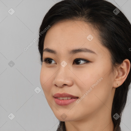 Joyful asian young-adult female with medium  black hair and brown eyes