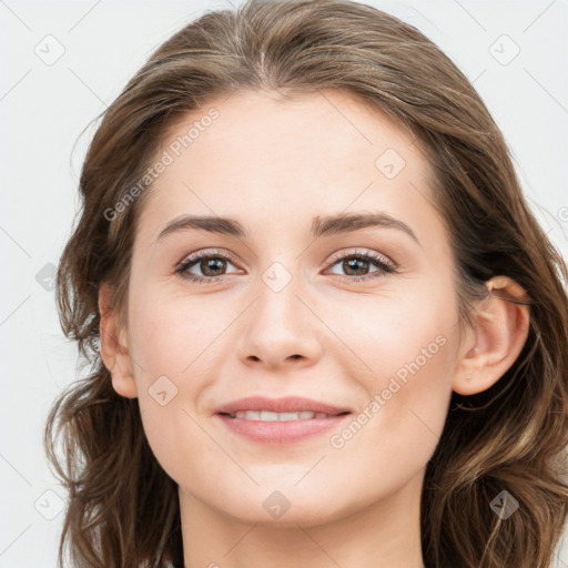 Joyful white young-adult female with long  brown hair and blue eyes