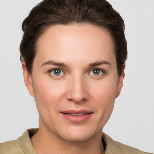 Joyful white young-adult female with short  brown hair and grey eyes