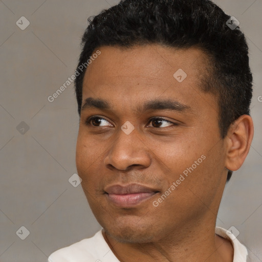 Joyful black young-adult male with short  black hair and brown eyes