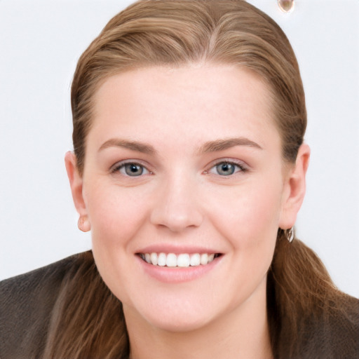 Joyful white young-adult female with long  brown hair and grey eyes